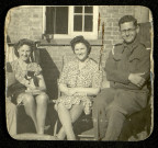 Portrait de Raymond Goldwater en uniforme assis à côté de deux jeunes femmes