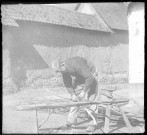 Scène rurale. Un homme préparant des lattes de bois