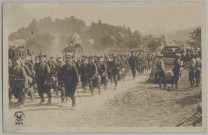 CARTE PHOTO MONTRANT UN REGIMENT EN MARCHE. OFFICIERS ET SOLDATS FRANCAIS EN TENUE DE 1914, FUSIL A L'EPAULE, MOUCHOIRS SUR LA NUQUE