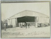 AEROPLANE HANGAR AT SALOBIKA. ON THE LEFT IS THE WRECKAGE OF A ZEPPELIN